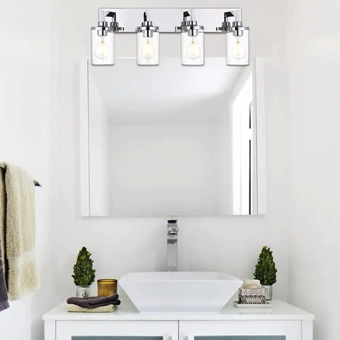 Sleek Chrome Finish Four Light Bathroom Vanity Light Fixture With Clear Glass Shades above a modern bathroom sink