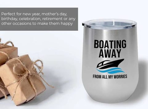 Boating Away 12oz insulated silver wine tumbler for pontoon boats and yachts, shown with gifts, focus on design and lid