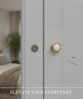 Close-up of Crackle Finish Ceramic Cabinet Knobs With Heavy Duty Zinc Alloy Core on a white cabinet door in a bedroom.