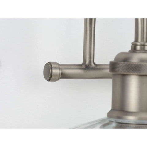 Close-up of Fayette Collection 3-Light Clear Glass Farmhouse Bath Vanity Light Antique Nickel showing steel bar and fixture detail.