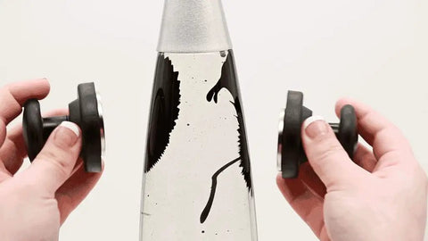 Retro Rocket Ship Ferrofluid Lava Lamp With Magnetic Black Wax In Clear Liquid, 15 Inch Tall, showing magnetic interaction