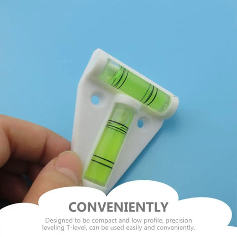 Mini T Shape Bubble Level Tool With Shatterproof PMMA And ABS held against blue background