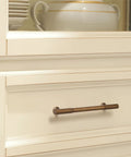 6 Pack Antique Brass Kitchen Cabinet Pulls With 5 Inch Center To Center Spacing installed on a white dresser drawer