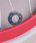 Close-up of one Two Pack Spoke Wrenches In Hardened Steel, resting on a bicycle wheel for rim truing and spoke adjustments.