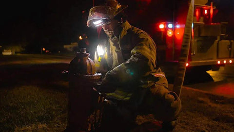 Firefighter using Command Tilt White LED Headlamp For Helmets 100 Lumen Fireproof And Waterproof Lighting at hydrant