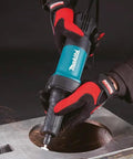 Knockout Performance One Quarter Inch Paddle Switch Die Grinder Slick 3.5 Amp Motor in use on metal surface, showing sparks.