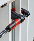 GearKlamp 6-Inch Clamp Set 4-Pack Built For Tight Spaces With Patented Gear Mechanism in use on cabinet frame