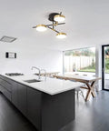 3 Light Dimmable LED Semi Flush Mount Ceiling Light Fixture In Modern Gold And Black illuminating a contemporary kitchen.