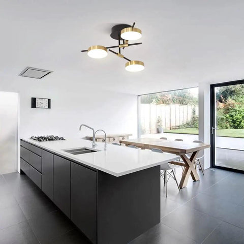 3 Light Dimmable LED Semi Flush Mount Ceiling Light Fixture In Modern Gold And Black illuminating a contemporary kitchen.