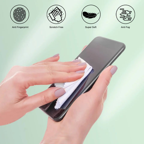 White microfiber eyeglass cleaning cloth (5x6 in) being used to wipe a smartphone screen.