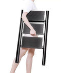 Person carrying Smooth Operator Electric Attic Ladder With Remote Control and Heavy Duty Handrail, demonstrating portability.