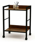 Two Tier Rolling Utility Cart With Brown Wood Shelves And Black Metal Frame On Wheels, front view in living room setup
