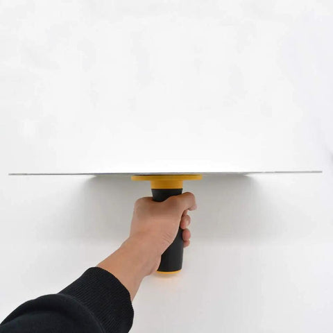 Hand holding Aluminum Plastering Hawk With 300x300 mm Mortar Board Holder And Soft Grip Handle, seen from side