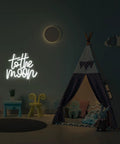 To The Moon Neon Sign LED Letters White Neon Light for wall decor in a children's room with a play tent and toys.