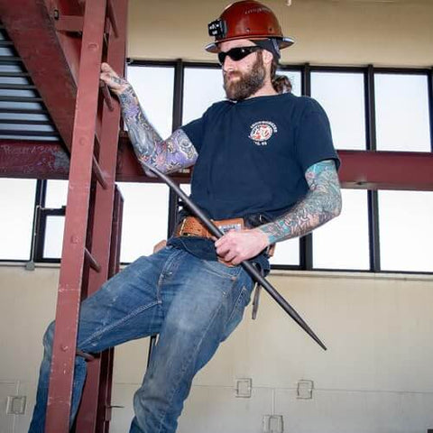 Worker using Ergonomic Round Connecting Bar 7/8 Inch Wide By 30 Inch Long With 15 Degree Angled Chisel, tapered end in construction.