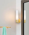 Saber Wall Sconce 1 Light 60W Max Honey Gold Finish 12.5 Inch High 4.75 Inch Wide Dimmable Bulb on wall near mirror