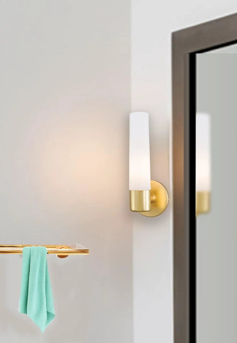 Saber Wall Sconce 1 Light 60W Max Honey Gold Finish 12.5 Inch High 4.75 Inch Wide Dimmable Bulb on wall near mirror