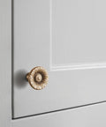 Six Pack Antique Brass Cabinet Knobs With Vintage Floral Drawer Pulls And Sunburst Design on gray cabinet door