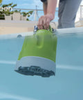 Front view of Green Expert submersible sump pump with green body and gray base lowered into a pool.