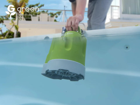 Front view of Green Expert submersible sump pump with green body and gray base lowered into a pool.