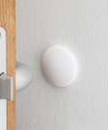 Three Piece Wall Doorstop Set With Self Adhesive Silicone Bumper Pads installed on wall protecting from door impact