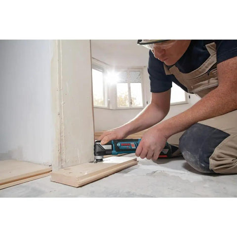 Person using 18V EC Brushless Oscillating Multi Tool With StarlockPlus Quick Change System for flush cut on doorway trim