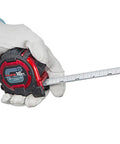 Gloved hand holding Pro Grade Tape Measure 16 Ft By 1 In GS Lock Standard Scale With Shock Resistant Case And Acrylic Coated Steel Blade
