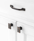 Five Pack 3 Inch Oil Rubbed Bronze Cabinet Pulls installed on white kitchen cabinets.