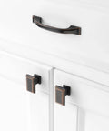 10 Pack 3 Inch Oil Rubbed Bronze Cabinet Pulls For Kitchen Cabinets Drawers Dressers Cupboards Solid Metal Hardware With Smooth Rounded Edges For Easy Grip And Cool Modern Look mounted on white cabinet doors.