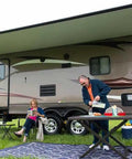Couple enjoying outdoor setup beside RV with Heavy Duty Flow Max Rv Water Pump With 50 Psi Pressure And 3 Gallons Per Minute Flow.