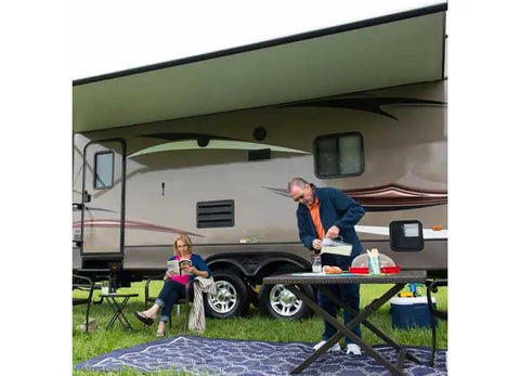 Couple enjoying outdoor setup beside RV with Heavy Duty Flow Max Rv Water Pump With 50 Psi Pressure And 3 Gallons Per Minute Flow.