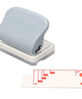 Super Handy Portable 3 Hole Puncher For Loose Leaf Paper A4 A5 B5 With 5 Sheet Capacity And Built In Positioning Ruler shown with ruler