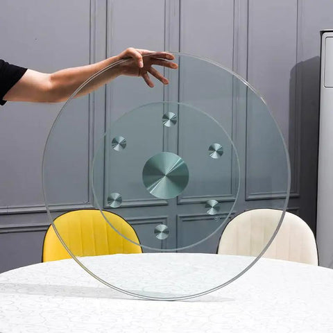 Super Smooth Tempered Glass Lazy Susan For Dining Table 360 Degrees Turntable held above a table, showcasing its round design and base.