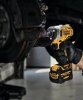 12V Max 3/8 Inch Cordless Impact Wrench Kit delivering hella tight torque, being used on brake rotor for quick automotive fixes.