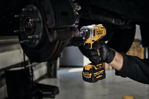 12V Max 3/8 Inch Cordless Impact Wrench Kit delivering hella tight torque, being used on brake rotor for quick automotive fixes.