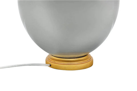 Close-up of 27 Inch Stoneware Table Lamp With Linen Shade In Grey And Gold Finish showing ceramic base and power cord.