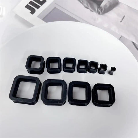 Rectangle Silicone Ear Tunnels And Plugs 00G 10MM Hollow Square Flexible Gauges Set in black, arranged on white surface
