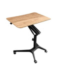 Hella Stable Mobile Standing Desk Featuring Instant Gas Spring Lift And Smooth Glide Rollers For A Total Game Changer Home Office Upgrade Or Flexible Workspace Setup In Clean Black with wooden top.