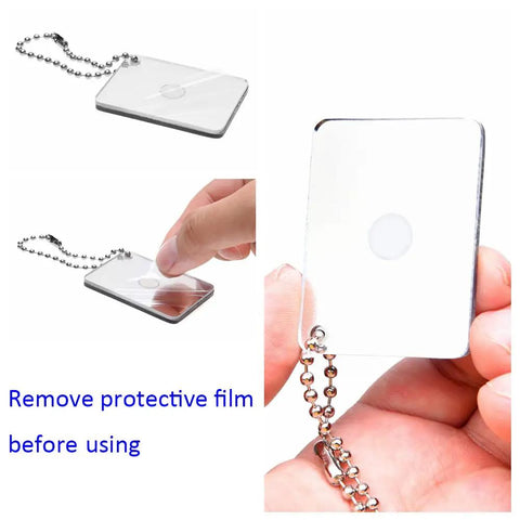 Reflective signal mirror with chain from 2X Survival Whistles With Lanyards And 2X Reflective Signal Mirrors kit, protective film being removed
