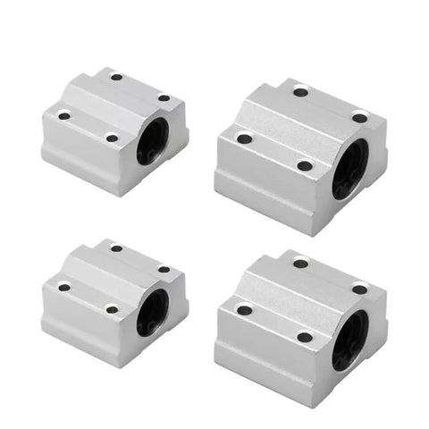 Badass Universal Linear Motion Ball Bearing Slide Block Bushing For CNC 3D Printer Shaft Guide Tough Aluminum Housing Smooth Glide High Quality Replacement Parts set of four silver aluminum slide blocks with black bearings.