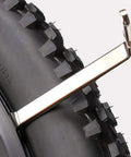4 Piece Stainless Steel Tire Levers Set For Bikes, ergonomic grip crowbars showing tire removal on mountain bike tire