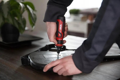 Person using Rechargeable 4V Cordless Screwdriver With Circuit Sensor Technology for home repairs