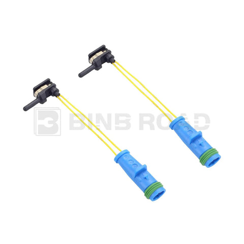 Front view: two brake pad wear sensor cables with blue housings and yellow wires.