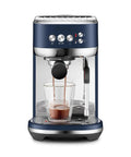 Damson Blue Kickass Espresso Coffee Maker Featuring Auto Milk Frother Quick Heat Technology And Reliable Pressure Pumping For Next Level Barista Quality Home Brews Any Day, brewing espresso into a glass.