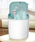 Knock Out Your Laundry Hustle With Slick Portable Mini Washing Machine Featuring blue drum as a hand places thin garment inside.