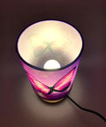 Top view of Chic Purple Butterfly Table Lamp With Wooden Base Bedside Light, glowing with included 3W LED bulb.