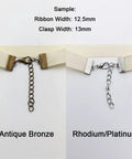 Close-up of 100 Sets Bronze Ribbon Crimps Kit With Lobster Clasps And Chain Extenders for DIY jewelry, showing clasp detail.