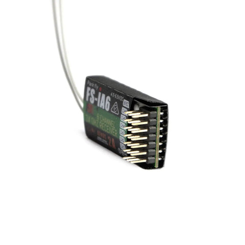 Close-up of FS-iA6 6-Channel 2.4GHz RC Receiver With Dual Antennas, showing connector pins and compact design.