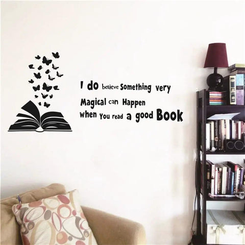Reading Book Wall Decal Open Book With Butterflies And Inspiring Quote For Kids Study Room Bedroom Decor Black Vinyl Peel And Stick 60x28 Inches Perfect For Kids Room Nursery, shown on wall above sofa and bookshelf.