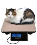 Heavy Duty Digital Shipping Scale With Six Hundred Sixty Pound Load And Smooth Stainless Steel Platform For Real Deal Accurate Parcel Weighing Plus Straight Up LCD Readouts with a cat on the platform.